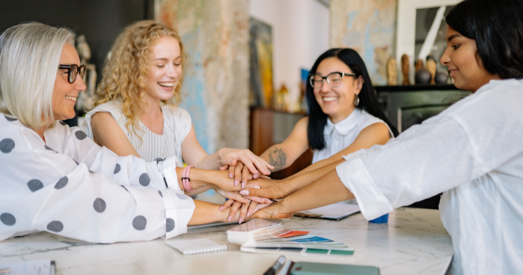 Critical Incident Stress Management A team of colleagues putting their hands together in support to manage workplace stress and crisis